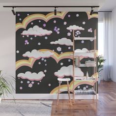 a wall mural with clouds, flowers and rainbows in the sky on a black background