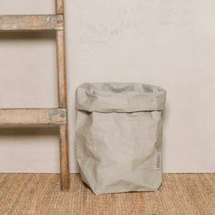 a bag sitting on the floor next to a ladder