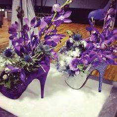 two purple high heeled shoes with flowers in them