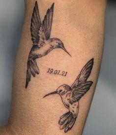 a tattoo with two hummingbirds on it