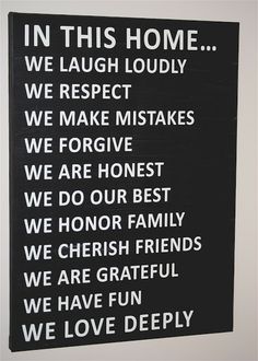 a black and white sign that says in this home we laugh