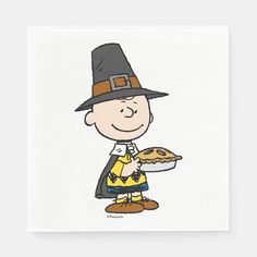 a cartoon character holding a pie on top of a white paper napkin with an orange and black hat