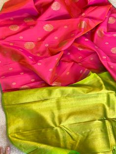 This stunning borderless kanjivaram silk saree in peacg shot with magenta pink is handwoven. The selvedge and the grand pallu is in parrot green color. The body is adorned with floral motifs in different sizes in gold zari. The blouse piece is in the same color as the pallu. Approximate Length 6.5 mtrs (inclusive of blouse length)Approximate height - 44 - 50” Approximate weight - 1.6 lbs Kindly Note : The colors you see on your device may vary due to the color reproduction, brightness and resolution of individual devices. If you'd like more clarity before your purchase, please contact our support team. Pink Banarasi Silk Saree With Tilla Detailing, Green Art Silk Saree With Tilla Details, Pink Art Silk Saree With Tilla Detail, Green Embroidered Art Silk Saree, Pink Art Silk Traditional Wear With Tilla Detailing, Bollywood Pink Saree With Tilla Details, Bollywood Style Pink Saree With Tilla, Pink Bollywood Saree With Tilla, Parrot Green