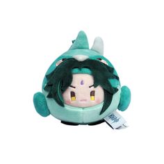 a small stuffed animal with green hair and eyes on it's head, sitting in front of a white background