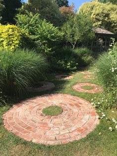 a brick path in the middle of a garden