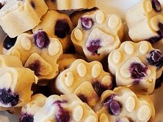 a white plate topped with cookies covered in blueberries