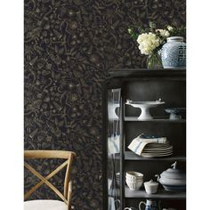 a black and gold wallpaper with white flowers in vases on the top shelf