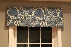 a blue and white window valance with flowers on it