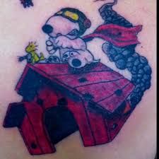 a tattoo with a dog on top of a birdhouse and birds flying above it