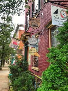 a red brick building with many signs on the front and side of it's windows