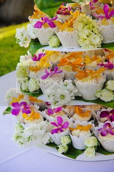 a table topped with cupcakes covered in flowers