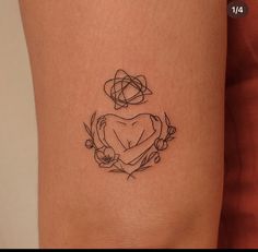 a woman's thigh with a heart tattoo on it