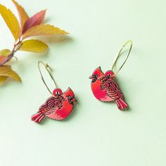 "These adorable red cardinal bird earrings are a bright pop of color for bird lovers! These original beauties are inspired by the male northern cardinal species ('Cardinalis cardinalis') with their plump bright red bodies, mohawk, and black mask. They are digitally illustrated and laser-etched on cherry wood and meticulously hand-painted in a palette of vermillion, burgundy, black. Super lightweight and cute, these little guys make a great gift for bird lovers and are mini works of art for your ears! Option #1: Silver Hoops These earrings feature silver 20mm 316 surgical stainless steel hoops with a simple loop and hook closure. Option #2: Gold Hoops These earrings feature gold 20mm 316 surgical stainless steel hoops with a simple hook closure. Option #3: Silver Ear Wires These earrings fe Red Cardinal Bird, Bright Pop, Northern Cardinal, Cardinal Bird, Cardinal Birds, Red Cardinal, Bird Earrings, Black Mask, Wood Earrings