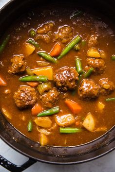 meatballs and vegetable stew in a pan on the stove