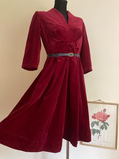 ♥ Vintage festive holidays wine red velvet dress. ♥ Simply gorgeous and flattering with V neckline and pleated A-line skirt. ♥ 3/4 sleeves, interesting ruffled waist detail. ♥ Color: deep wine red / dark red.  ♥ Fabric: unknown, possibly polyester and viscose blend.  ♥ Not lined, can be worn with a belt if you wish to accentuate your waist. ♥ Side zipper. ♥ Good vintage condition with some minor signs of wear. ♥ Brand: tailored, handmade. Size: no tag, should fit best DE40-42 US10-12 UK14-16 L. Fitted Velvet V-neck Dress For Holidays, Red Velvet V-neck Party Dress, Vintage V-neck Winter Dress, Velvet A-line Dress For Winter, Fitted Burgundy Dress For Christmas, Burgundy Formal Dress For Christmas, Christmas Formal Burgundy Dress, Holiday Velvet V-neck Dress, Fitted V-neck Velvet Holiday Dress