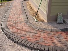 a brick walkway next to a house