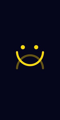 a yellow smiley face with two eyes on a black background, the image is very dark