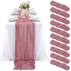 the table is set with pink linens and place settings