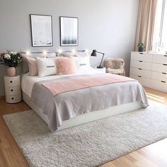 a bedroom with a bed, dresser and two framed pictures on the wall above it