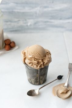 a scoop of ice cream and spoons on a table