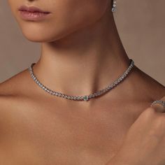 Our Celeste Tennis Necklace is epitome of classy and iconic. Dazlling enough on its own, but looks even more glamorous if you add on the matching Celeste Tennis Bracelet and earrings for a red-carpet ready look. This necklace guarantees an unforgetttable impression. - Rhodium Plating over Brass- Cubic Zirconia- Length approximately 16.5"- Available in White Gold only Tennis Necklace Diamond, Diamond Tennis Necklace, Cultured Pearl Necklace, Necklace Diamond, Gold Statement Necklace, Bow Jewelry, Birthstone Pendant, Tennis Necklace, Statement Pendant