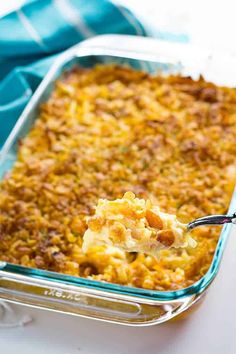 a spoonful of macaroni and cheese being lifted from a casserole dish