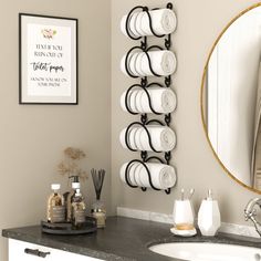 a bathroom with a sink, mirror and towel rack