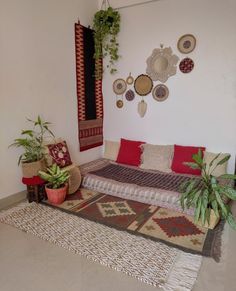 a living room filled with lots of furniture next to a wall mounted hanging planter