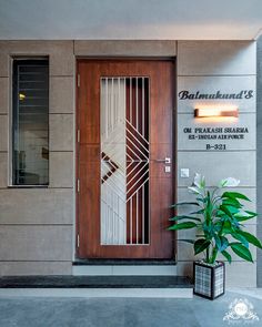 an entrance to a building with a potted plant next to it