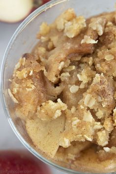 an apple pie in a glass bowl with some toppings