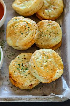 some biscuits and dipping sauce on a tray