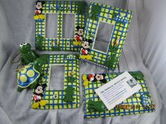 three frames with mickey mouse and frog designs on them, one has a key chain attached to it