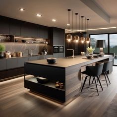 a modern kitchen with an island counter and bar stools next to the window that looks out onto the water