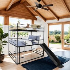 a loft bed with a slide in the middle