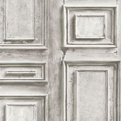 an old door with peeling paint on the front and side paneled in grey tones