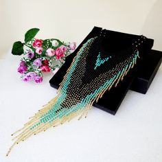 "Luxurious exclusive necklace for special occasions.Flowing tassel beads necklace.Bohemian dangle beaded necklace with fringe are made of high quality Czech and Japanese seed beads. long earrings.Bead weaving techniques. Colors: Blue turquoise ,Matte black and gold color ! Details ! Made with quality Japanese and Czech seed beads ! Professional threads for weaving with beads Tytan and Fireline. ! neck girth length 15 inches.Neck length can be extended with an extension chain. ! The necklace is adjustable and fits any size.  The length of the falling necklace is 9.5 inch, ! INSTRUCTIONS FOR USE. Please avoid getting alcohol-containing cosmetics (Perfume ,deodorant, lotions) on jewelry. Please take off your jewelry before showering, sauna and sea access. You can store your jewelry in the pro Bohemian Gold Tassel Necklace For Party, Bohemian Gold Beaded Necklaces With Tassels, Turquoise Beaded Necklaces With Tassels For Gift, Turquoise Tassel Necklaces For Festivals, Festival Fringe Choker Necklace, Fringe Choker Necklace For Festival, Elegant Beaded Tassel Necklace For Festivals, Bohemian Gold Necklace With Beaded Fringe, Bohemian Fringe Choker Jewelry