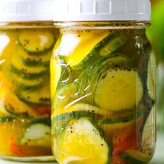 pickles and cucumbers are in a jar on the shelf next to each other