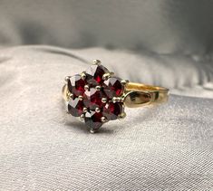 A beautiful genuine antique German silver garnet ring (natural stone), hallmarked '900' for silver, US Size 5 3/4, in good antique condition, would make a nice gift for someone special! Material: 900 silver, garnet Weight: 1.8 g US Size: 5 3/4 (EU 51 1/2) Box on photos is NOT included. PLEASE LOOK AT THE PICTURES, THEY ARE PART OF THE DESCRIPTION AND ARE THE ACTUAL ITEM YOU WILL RECEIVE. Victorian Ruby Cluster Ring With Gemstones, Vintage Red Garnet Cluster Ring, Vintage Garnet Cluster Ring As Gift, Vintage Ruby Cluster Ring With Gemstone, Vintage Ruby Cluster Ring Hallmarked, Vintage Garnet Cluster Ring For Anniversary, Vintage Garnet Cluster Ring With Gemstone, Vintage Garnet Cluster Ring, Antique Hallmarked Garnet Ring