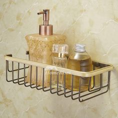 a bathroom shelf with soap, lotion and hand sanitizers on it in front of a marble wall