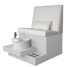 a white chair sitting on top of a table next to a sink and soap dispenser