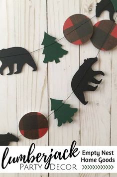 some paper animals and trees hanging from a string on a white wooden background with text overlay