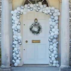 a door decorated with silver and white balloons