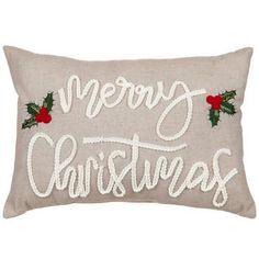 a christmas pillow with the words merry christmas written on it and holly berries in red