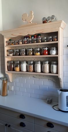 the shelves above the stove are filled with spices