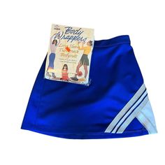 Check Out This Fun Cheerleaders Uniform Royal Blue And White The Top Is Actually A Long Sleeved White Leotard Made By Body Wrappers. It Zips Up The Back And Is A Size Adult X-Small. It Will Comfortably Fit Up To A 32" Chest. The Royal Blue Skirt Is An A-Line Style With The Right Corner Having Metallic Silver / Blue And White Colored Banding. It Buttons And Zips In The Back And Has 2 Button Placements To Choose From. It Will Comfortably Fit A 22 To 24" Waist. It Measures 14" In Length. The Leo Is Fitted Blue Skort For Cheerleading, Blue Stretch Skort For School, Retro Blue Fitted Skort, Fitted Blue Bottoms For Cheerleading, Blue Fitted Bottoms For Cheerleading, Royal Blue Skirt, White Leotard, Royal Blue Skirts, Outfit Costume