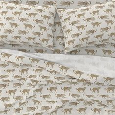 an image of a bed with leopards on it's sheets and pillow cases