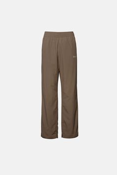 DUME NYLON PANT Brown Parachute Pants With Elastic Waistband For Streetwear, Brown Cotton Utility Parachute Pants, Mid-rise Cotton Parachute Pants With Multiple Pockets, Vintage Brown Cotton Pants, Elwood Clothing, High-waisted Brown Cotton Parachute Pants, Nylon Pants, Back Pocket, Female Model