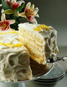 a piece of cake with white frosting and yellow icing is on a plate