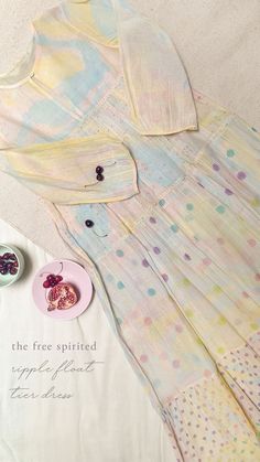 Feel spirited in our Ripple Float Dress tie dyed in pastel yellow with accents of fuchsia and arctic blue and hand block printed with flora and polka dot prints. Constructed in three tiers with soft gathers, this dress is an everyday autumn staple. Pakistani Designer Clothes