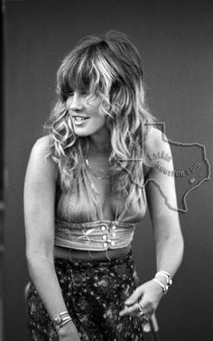 a black and white photo of a woman with long hair